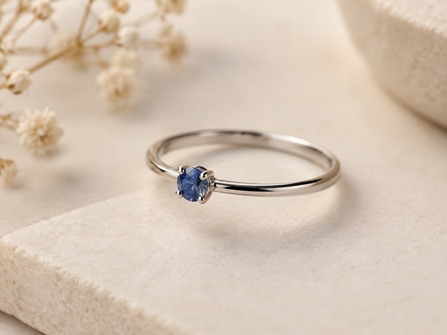 AI illustration of a silver-coloured ring with a small blue stone.