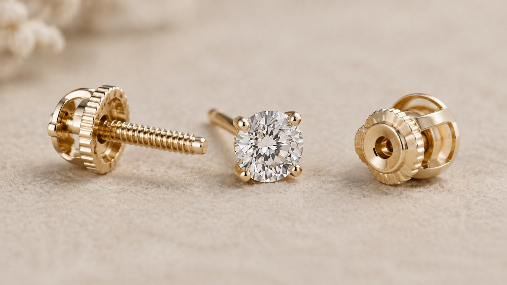 Screw back and locking earring backs beside a diamond stud