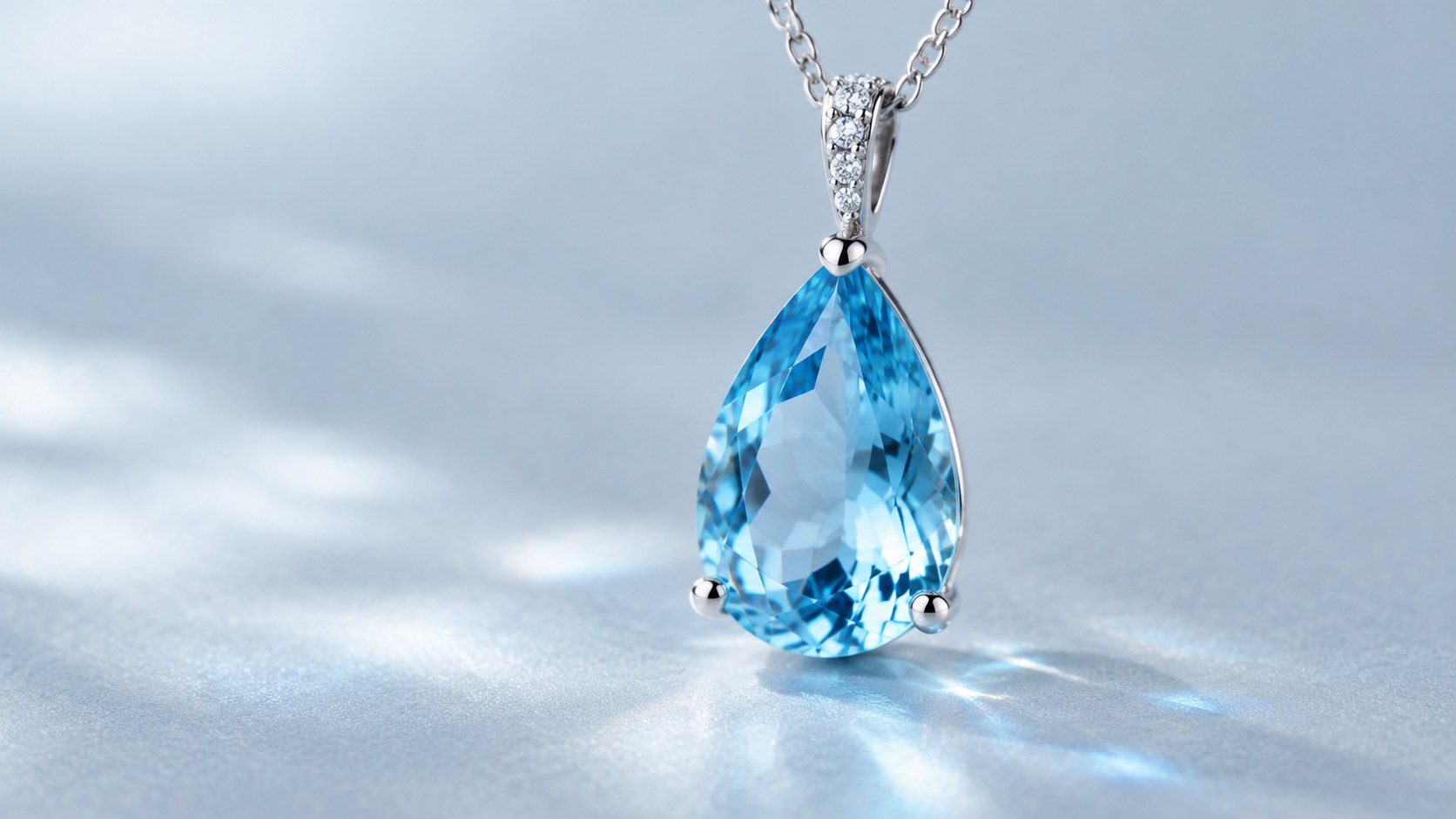 A bright sky-blue topaz pendant catching light