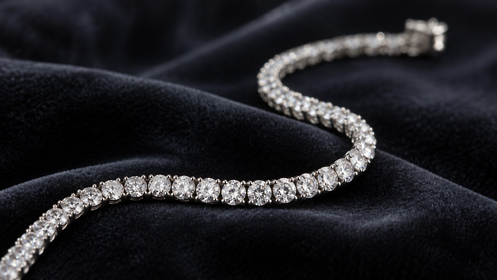 A flexible diamond line bracelet curving on dark velvet