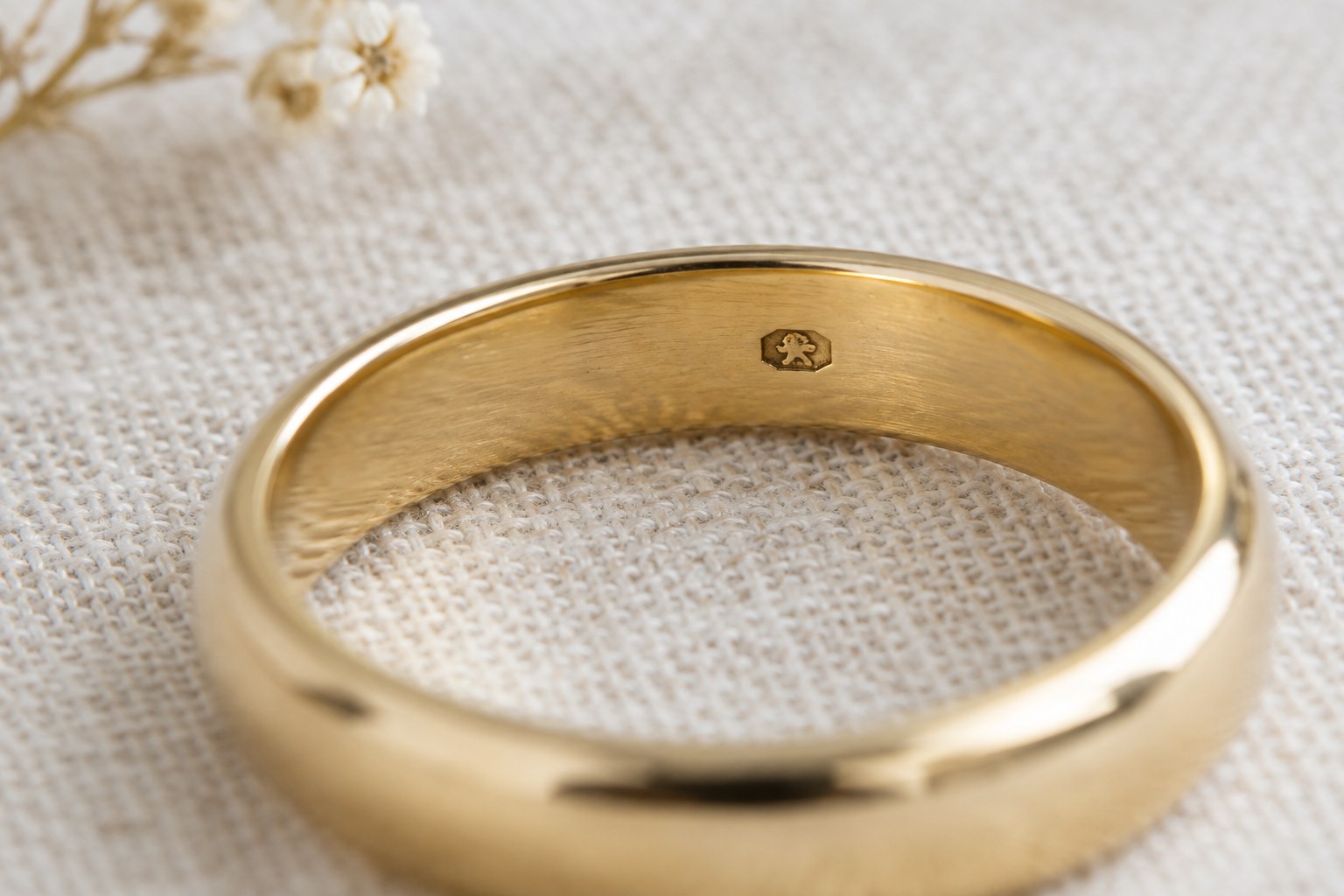 AI illustration of a close-up of a gold band interior with a tiny hallmark stamp.