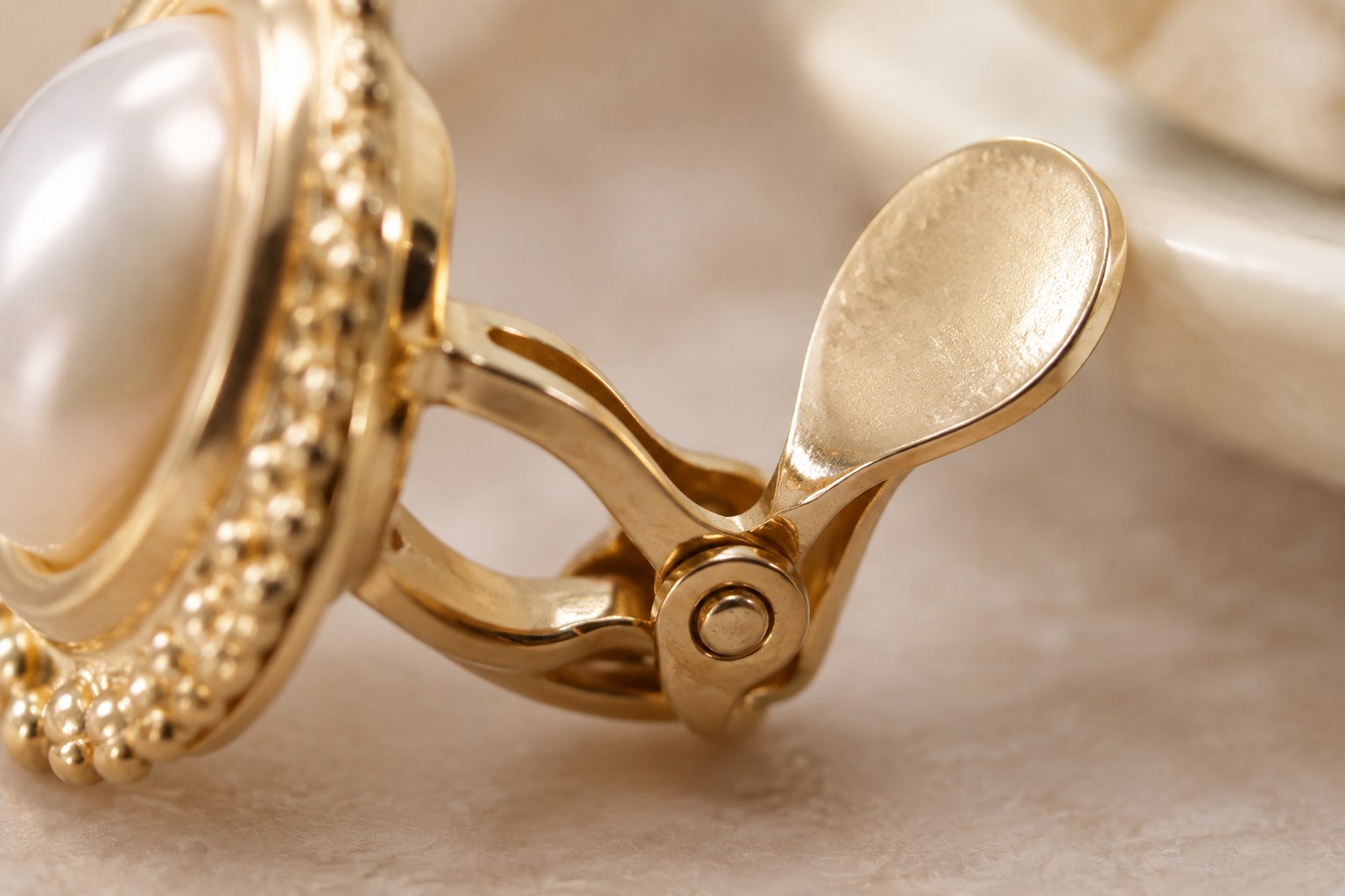 Illustration: macro of a clip-on earring hinge mechanism