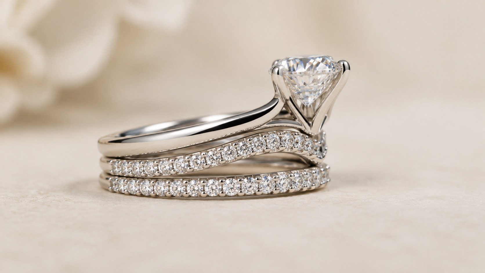 A solitaire engagement ring nested with chevron and eternity bands
