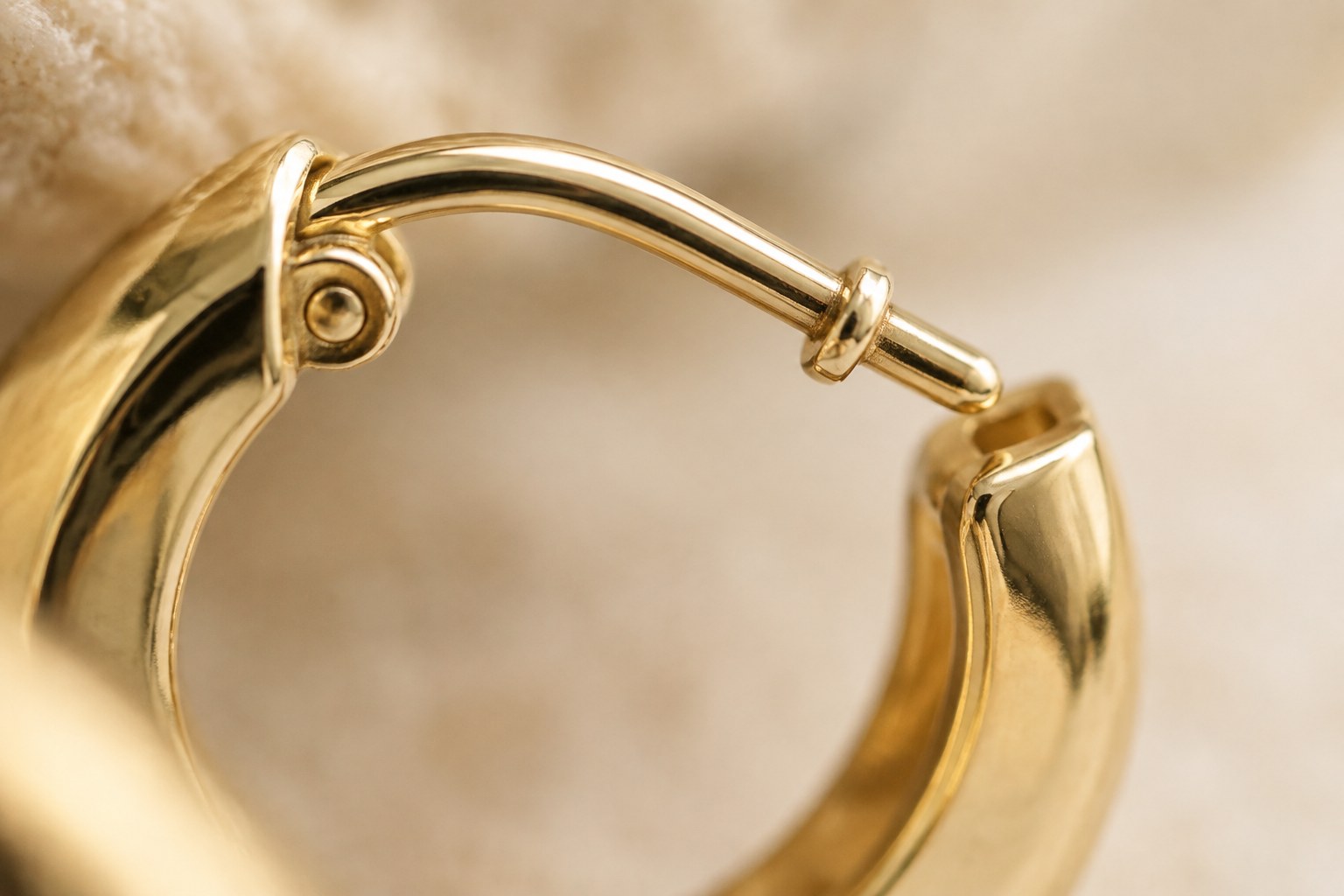 Illustration: extreme macro of a hinged hoop earring closure mechanism in gold