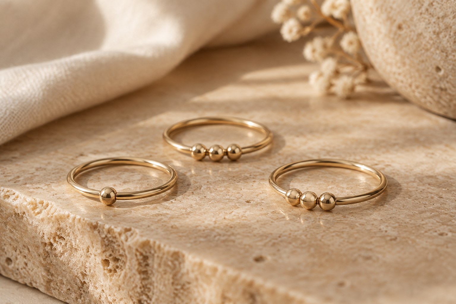AI illustration of gold fidget rings with rolling beads